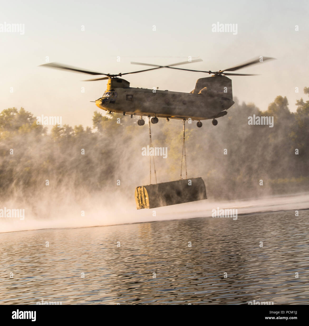 Eine Boeing CH-47 Chinook Staubsauger über den Arkansas River, die sich anschickt, eine Brücke Bucht während der Fluss Angriff 2018 am Fort Chaffee, Arche, 25. Juli 2018 fallen. Die Verwendung von Chinooks erhöht die Effizienz der Mission durch die Minimierung der Zeit zwischen Bay Tropfen, die sinnvolle Konstruktion führen. (U.S. Marine Corps Foto von Lance Cpl. Quentarius Johnson) Stockfoto