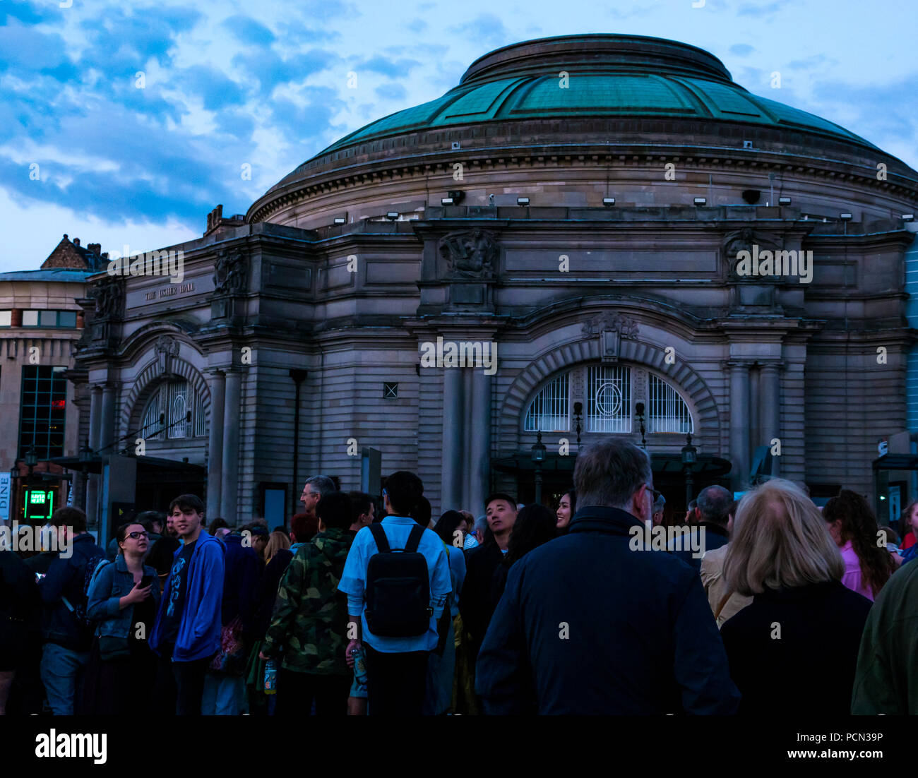 Edinburgh, Großbritannien. 3. Aug 2018. Aberdeen Standard Investitionen Sponsoren das Edinburgh International Festival 2018 Eröffnung fünf Telegramme mit einer Masse in Festival Square. Feiern Schottlands Jahr der jungen Menschen und auf das hundertjährige Jubiläum des Ende des Großen Krieges reflektieren mit beauftragt, Musik von Anna Meredith und digitale Projektion auf die Usher Hall von 59 Produktionen, die im Freien Fall wird durch Telegramme von jungen Soldaten im Jahr 1918 gesendet. Die Menge wartet auf den Anfang der Show Stockfoto