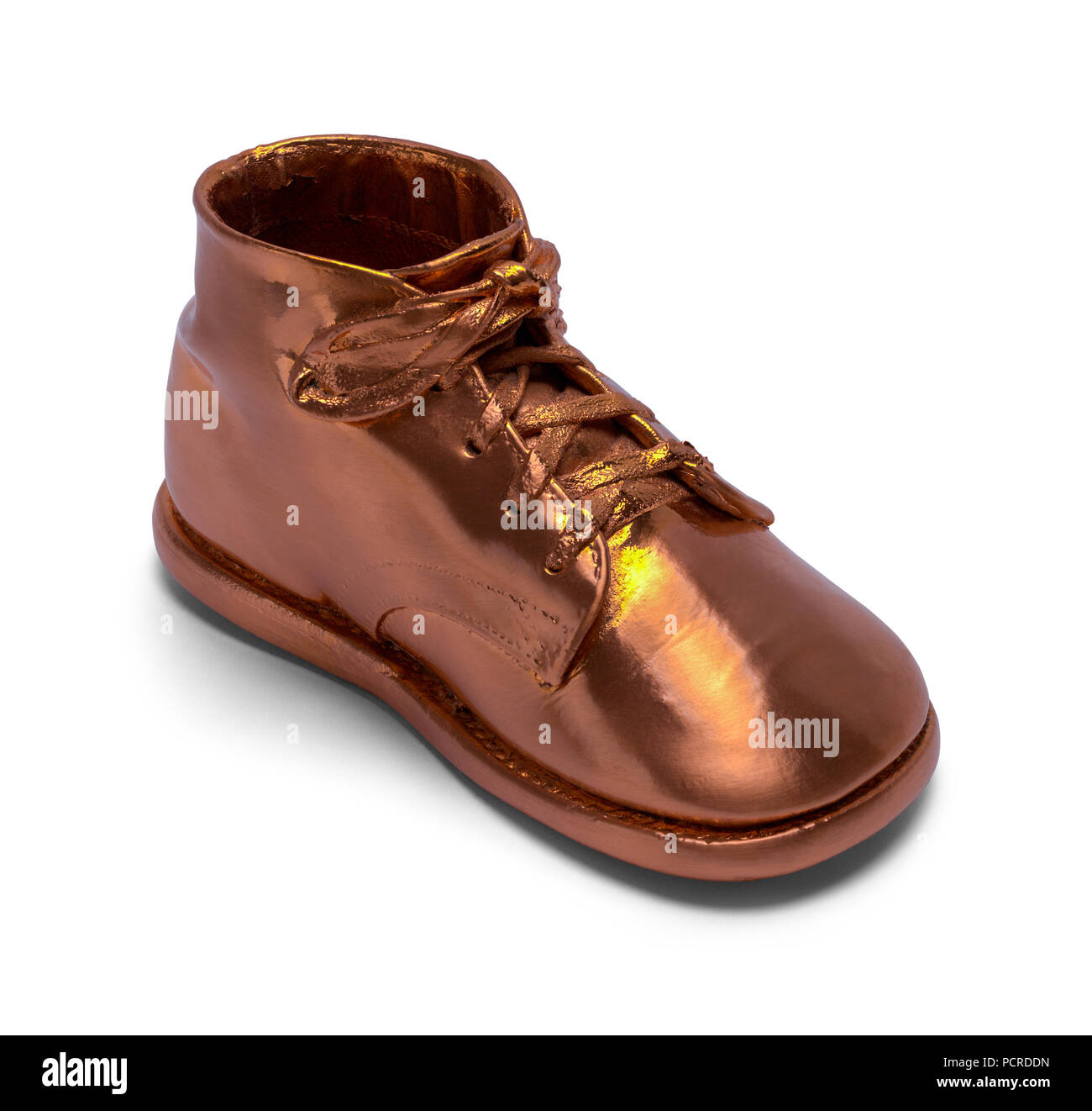 Bronze Baby Schuh isoliert auf einem weißen Hintergrund. Stockfoto