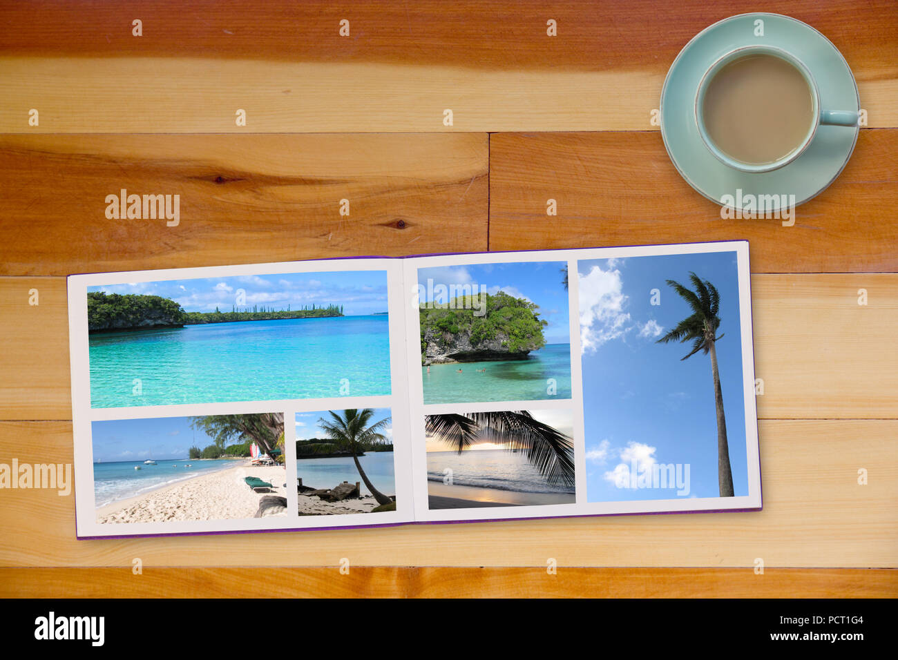 Fotobuch Album auf Holzboden Tabelle mit Reisen Fotos von Stränden und Kaffee oder Tee in Tasse Stockfoto