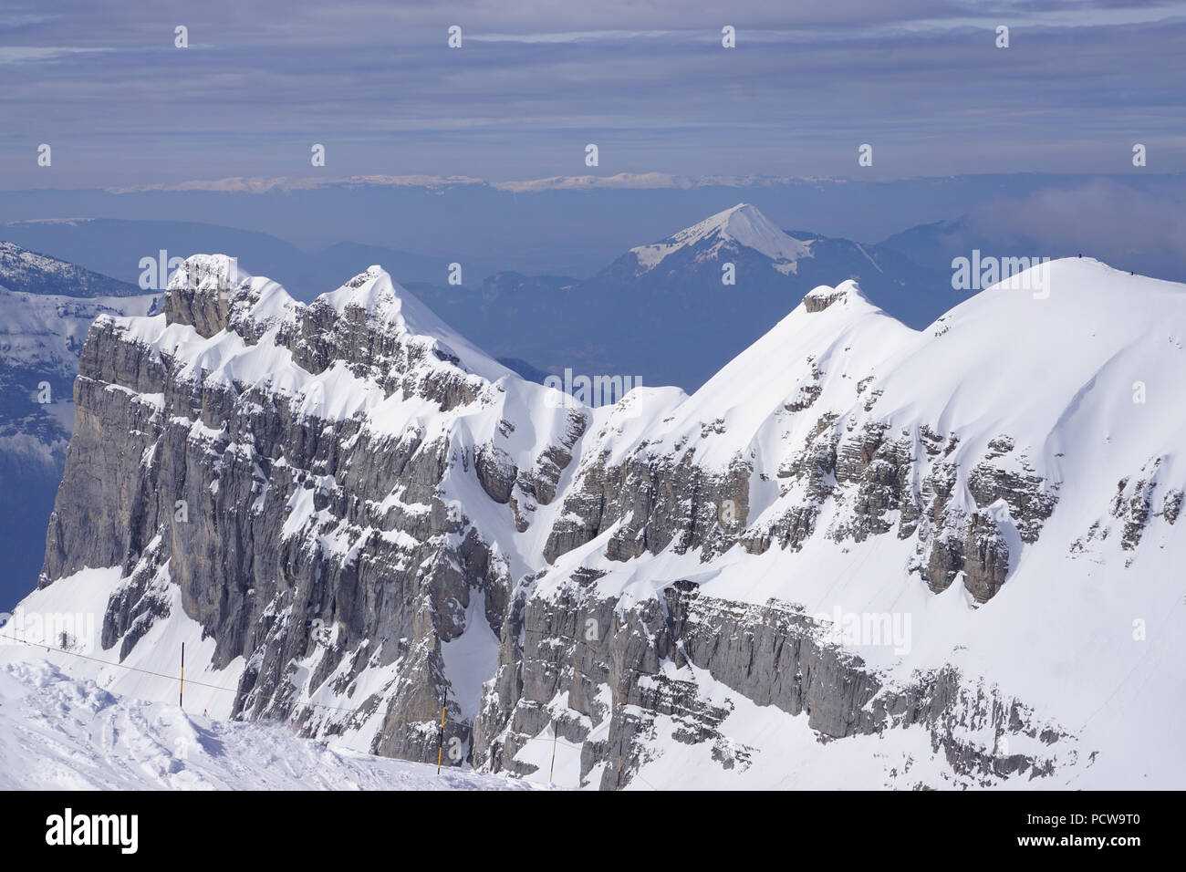 Blick aus der Vogelperspektive auf die felsigen schneebedeckten Bergspitze auf eine perfekte klare Skitag in den Alpen, in Frankreich und in den Tal mit anderen Gebirgsregionen Stockfoto