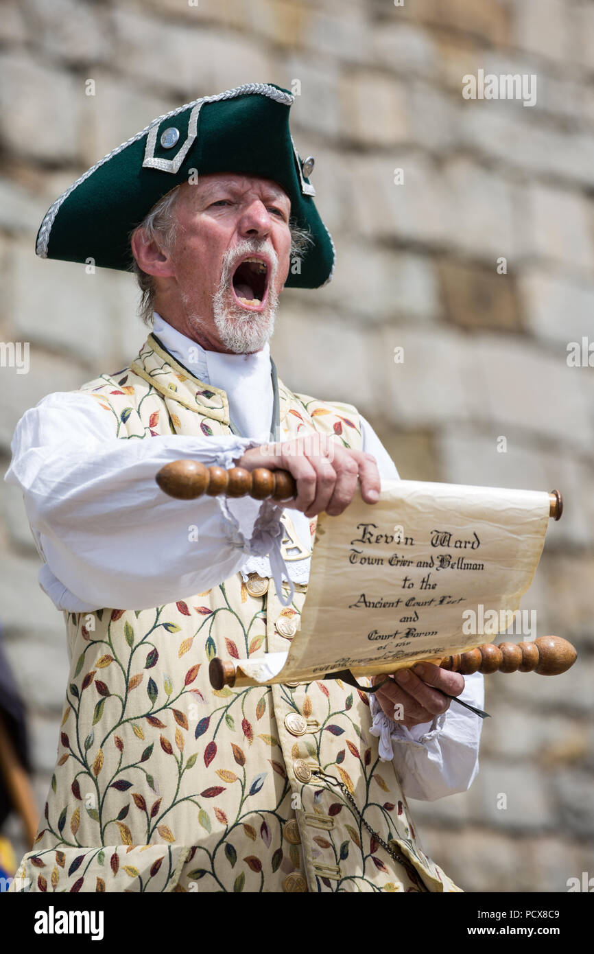 Windsor, Großbritannien. 4. August 2018. Kevin Ward, Stadtausrufer von Bromsgrove, beteiligt sich an der Antike und ehrenvolle Gilde Town Criers (AHGTC) nationalen Meisterschaft unter den Mauern von Schloss Windsor. 40 Town criers aus ganz Großbritannien und zwei aus Australien konkurrieren in zwei Runden von Weinen, die ersten, die ein Home Schrei auf Diktion, den Tonfall, die Klarheit und die Lautstärke und die zweite ein Schrei auf das Thema 'Feier' gezählt. Credit: Mark Kerrison/Alamy leben Nachrichten Stockfoto