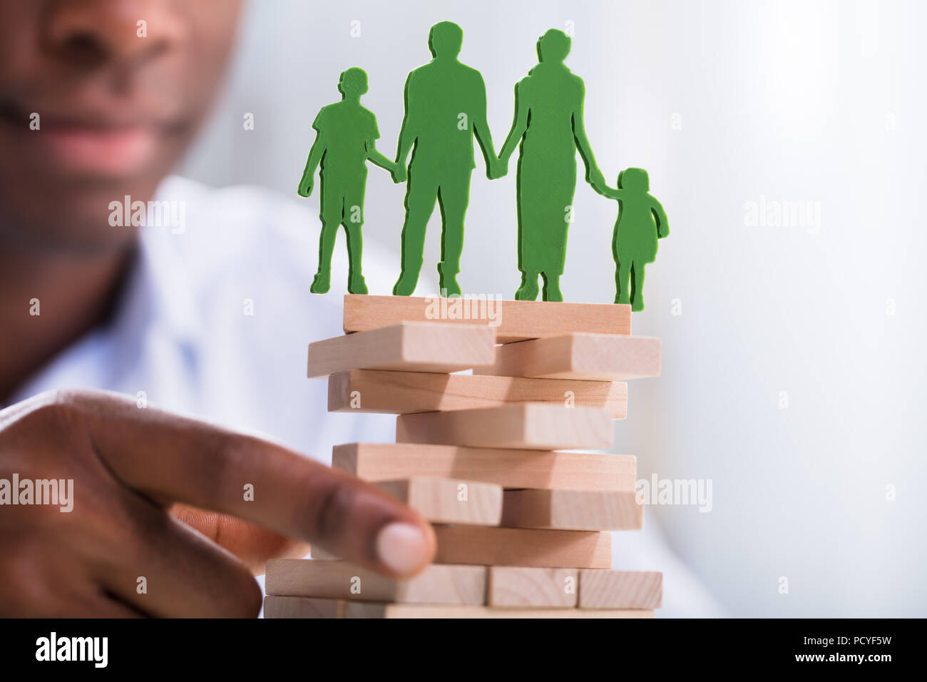 Nahaufnahme einer Person, die Blöcke mit grünen Familie Bilder oben Stockfoto