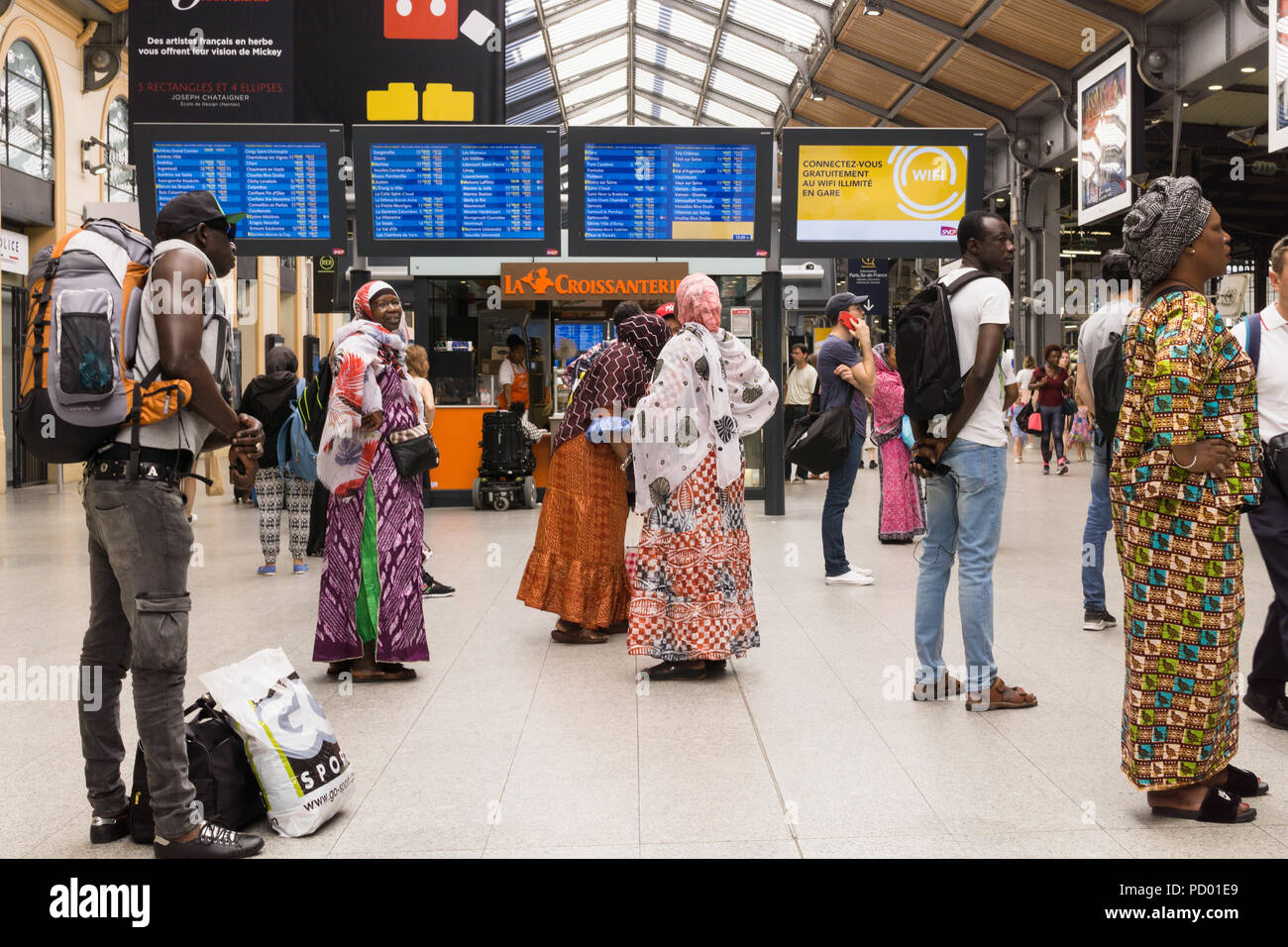 Gare de Saint Lazare Paris - Französische Frauen afrikanischer Herkunft überprüfen Sie die Fahrpläne am Gare Saint Lazare Bahnhof in Paris, Frankreich, Europa. Stockfoto