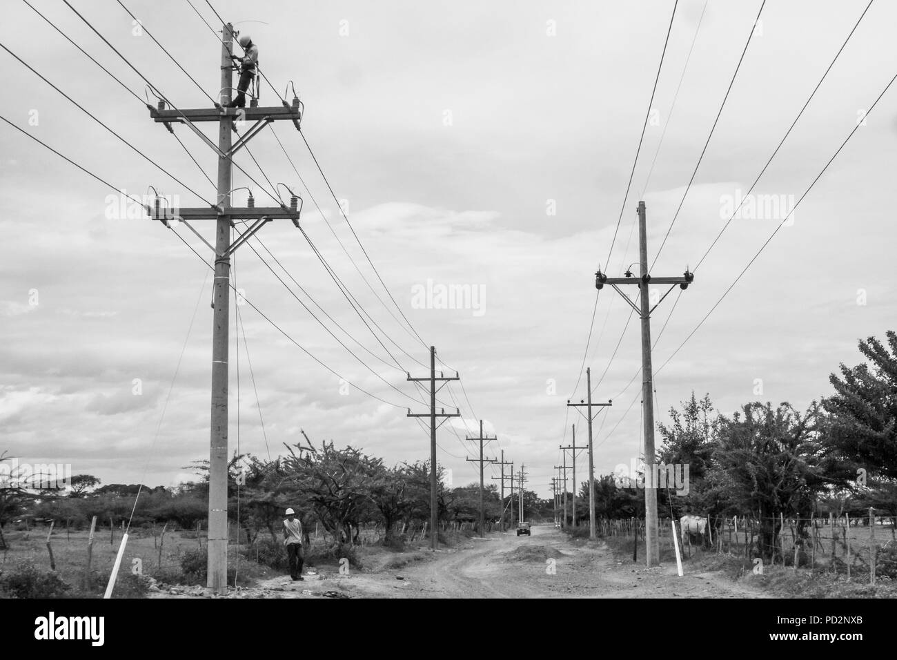 Arbeitnehmer in die Türme für den Anschluss neuer Power Line Distribution für Elektrizität in der ländlichen Umgebung von Honduras arbeiten Stockfoto