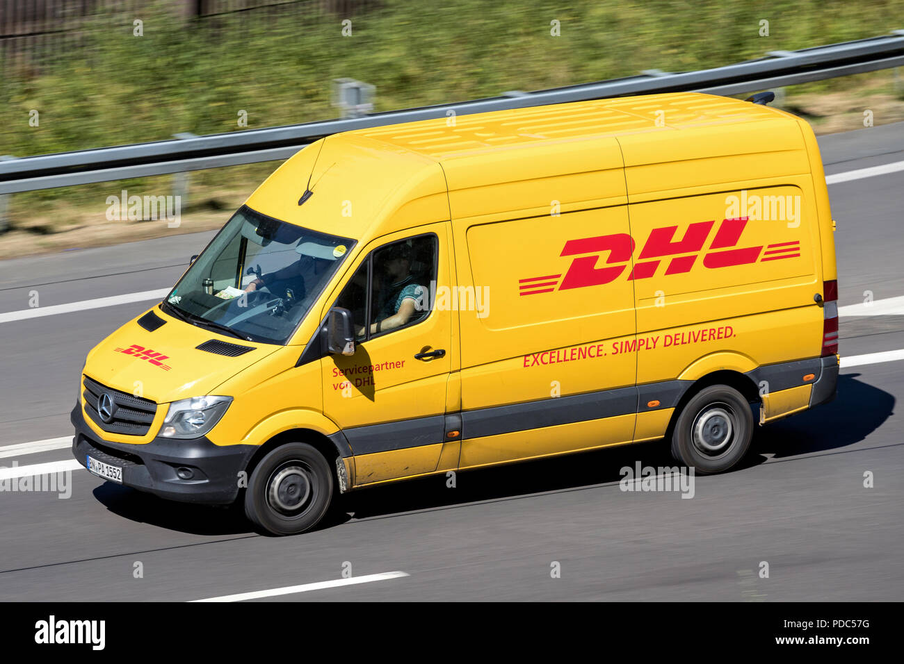 DHL-Lieferwagen auf der Autobahn. DHL ist eine Abteilung des Deutschen Logistikunternehmen Deutsche Post AG Die International Express Mail Service. Stockfoto