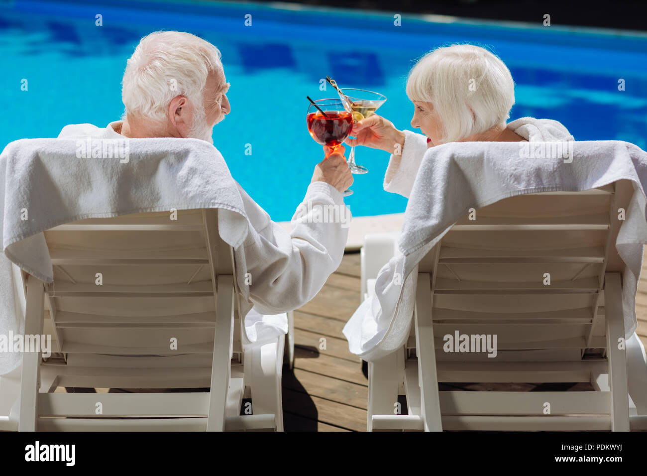 Der Mann und die Frau, die im Leben liegen in der Nähe der Pool im Ruhestand Stockfoto