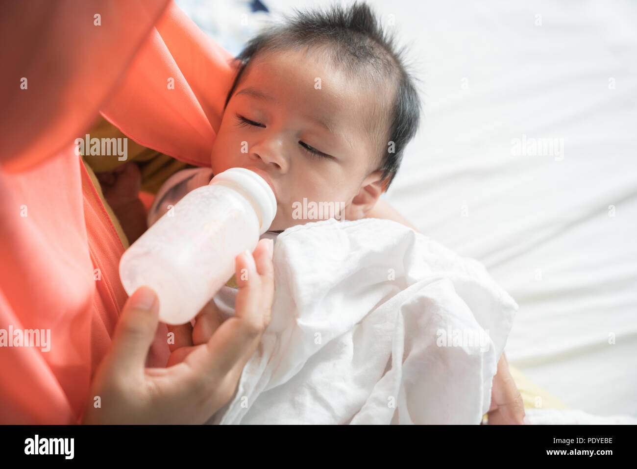 Mutter füttern Sie Ihr Baby mit milchflasche. Stockfoto