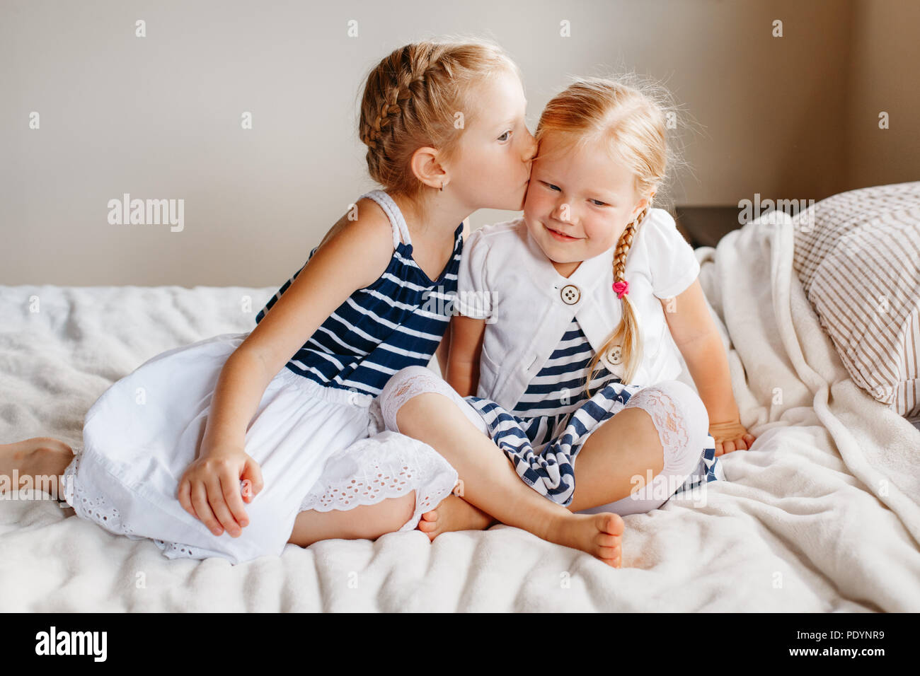 Two Kissing Cute Little Sisters Fotos Und Bildmaterial In Hoher two-kissing-cute-little-sisters-fotos-und-bildmaterial-in-hoher