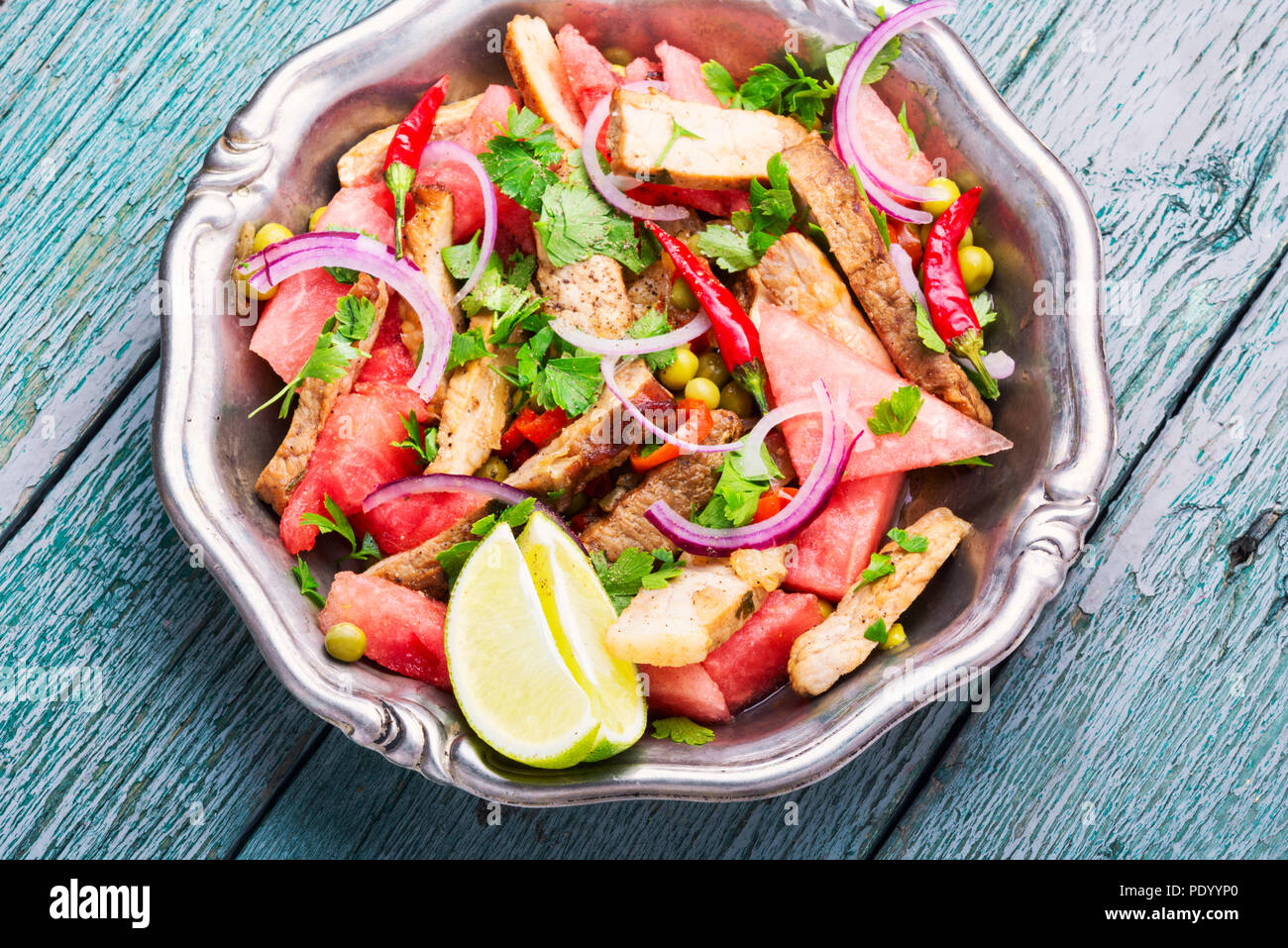Sommersalat mit Rindersteak, Wassermelone und Gewürzen. Exotische Lebensmittel, Stockfoto