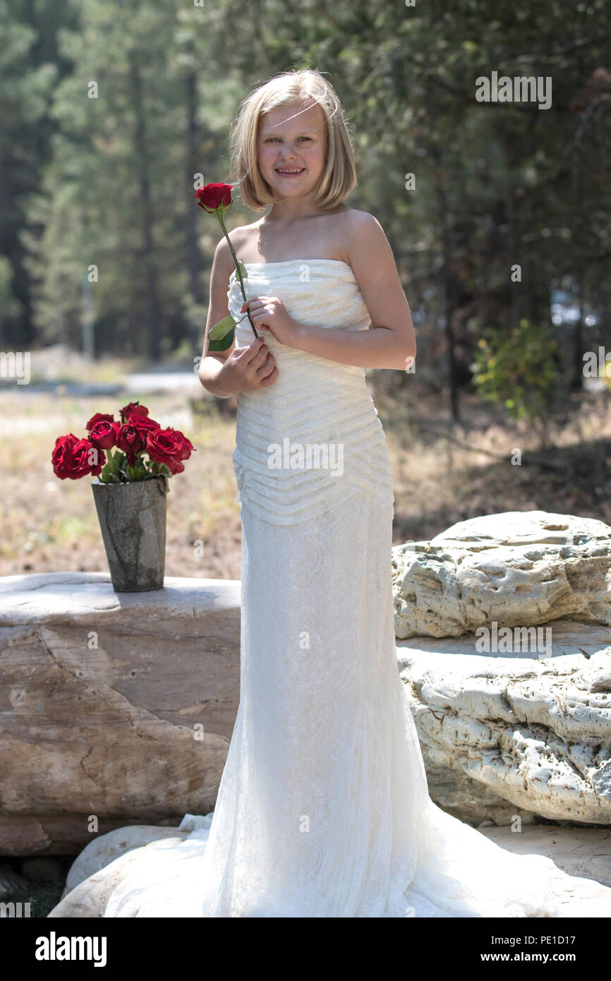 Fantasy 8 9 Jahr Attractie Blond Mit Einem Hochzeitskleid Der Tante Kleid Stehen Im Freien Rote Rose Neben Vase Mit Roten Rosen Lachelnd An Kamera Stockfotografie Alamy