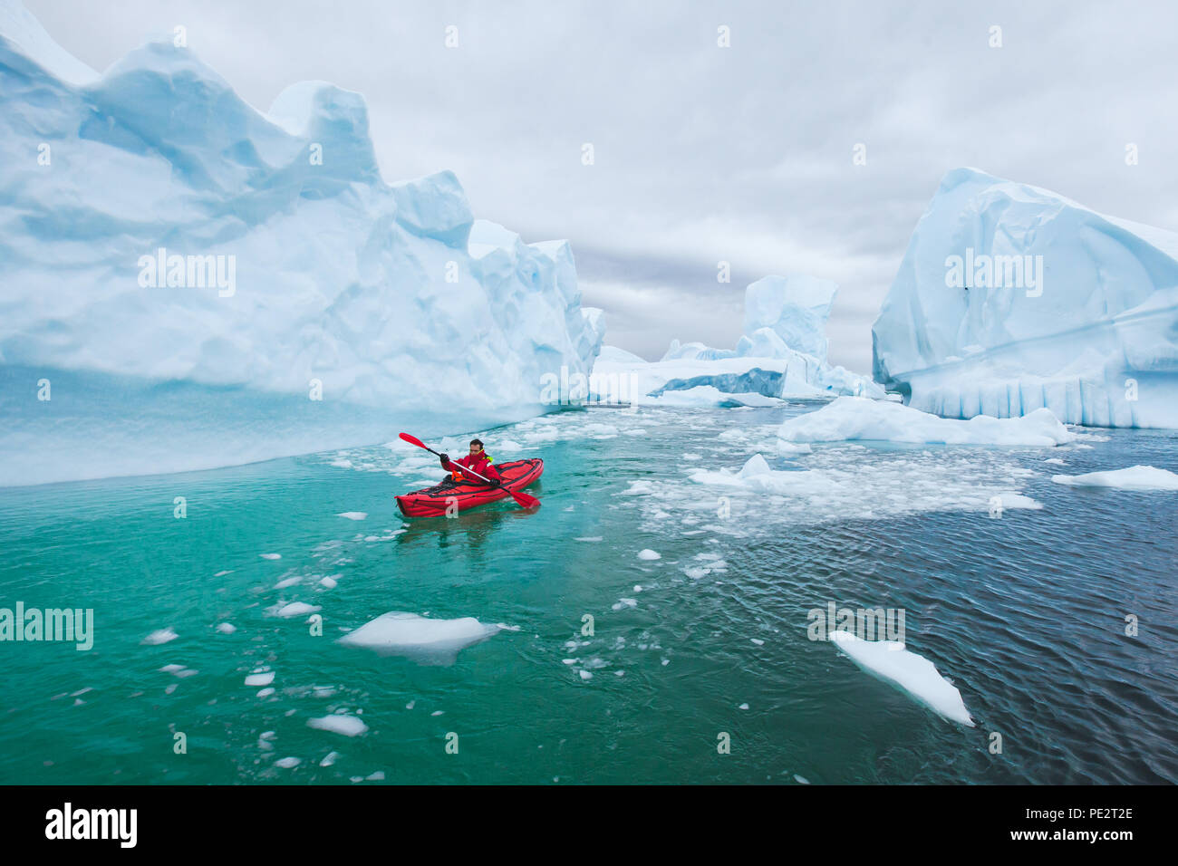 Man paddeln auf Kayak zwischen Eis in Antractica in Eisbergs Friedhof, extreme Winter Kajak, polar Abenteuer in der Nähe von pleneau Insel Stockfoto