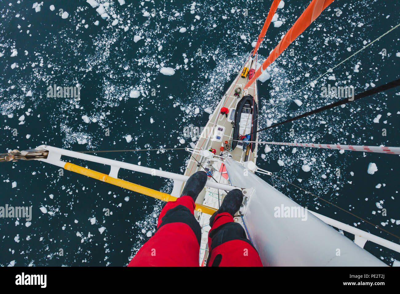 Segelboot in der Antarktis, extrem gefährliche Reisen selfie, Person, stehend am Mast einer Yacht mit schwimmenden Eis, Ansicht von oben, Abenteuer Stockfoto