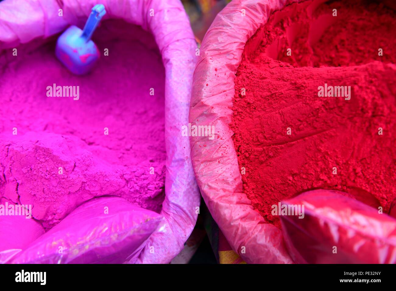 Behälter mit leuchtend farbigen rosafarbenen und roten Holi-Festival-Pulvern oder Gulal in Neu-Delhi, Indien Stockfoto