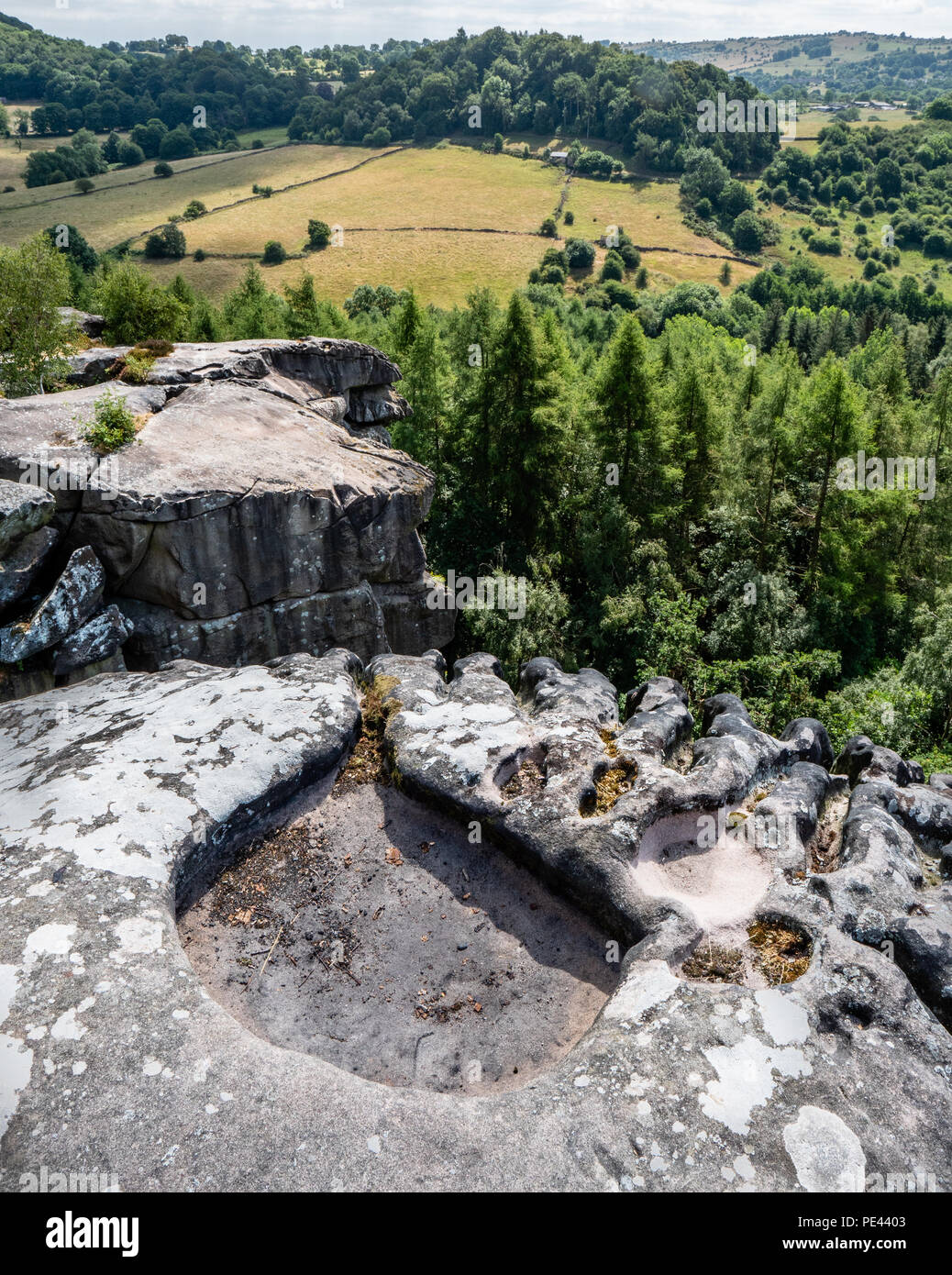 Cratcliffe Tor in der Nähe von The Staff Of Life in Derbyshire UK zeigen gritstone Kante, die durch Wind, Wasser und Kies in Rock Becken verwittert und Kannelierten runnels Stockfoto