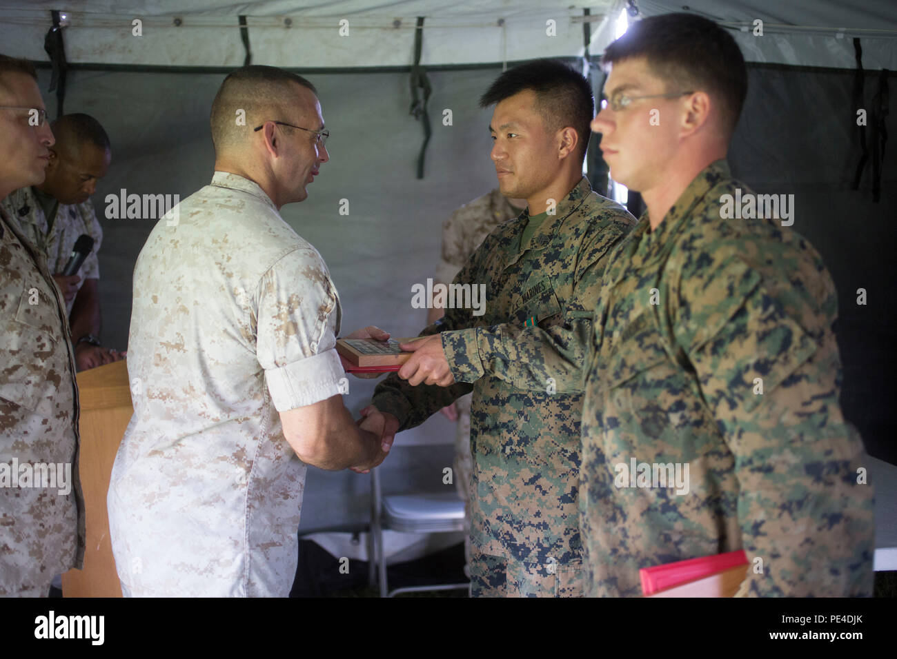 Us Marine Colonel Steven Wolf (links), Schule des Infantry-East befehlshabenden Offizier, schüttelt Hände mit Sgt. Je Ihr, während eine Auszeichnung für das erste Inverkehrbringen in der Bekämpfung der Kursleiter Stakes Wettbewerb auf Sept. 11, 2015. Die Combat Instructor Stakes ist ein anstrengender 32-Std.-Wettbewerb, in dem sich die zwei Mann, Combat Instructor Teams gegeneinander in physikalischen, taktische und Wissen Veranstaltungen beim Tragen einer Last und bekämpfen sich über 55 Kilometer zu Fuß. (U.S. Marine Corps Foto von SOI-E Bekämpfung Kamera, Cpl. Andreas Kuppers/Freigegeben) Stockfoto