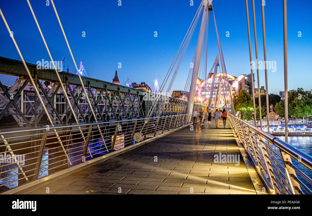 Menschen auf Hungerford Bridge bei Nacht London UK Stockfoto
