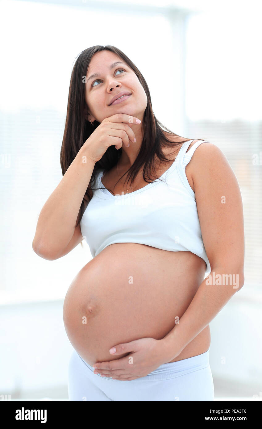 Porträt einer Träumen schwangere Frau Stockfoto
