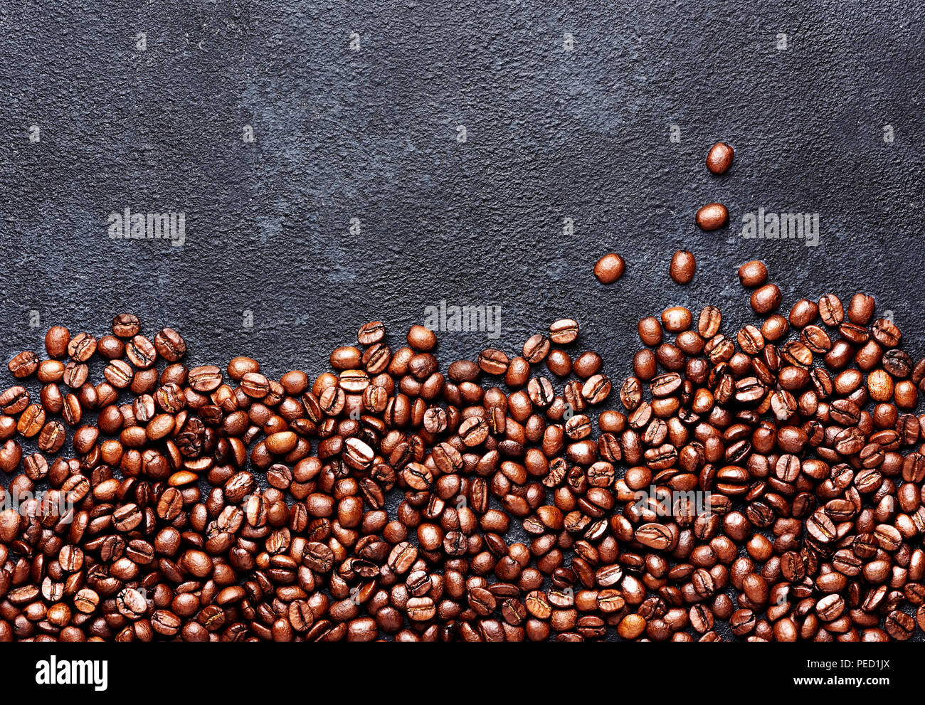 Kaffeebohnen auf Schwarz konkreten Hintergrund mit Papier. Ansicht von oben Stockfoto