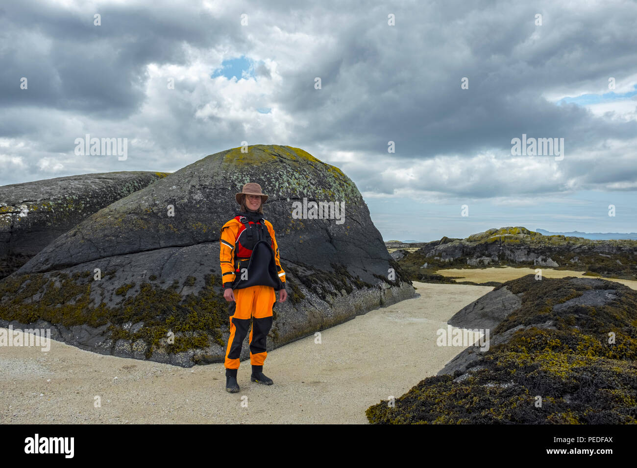 Junge Frau sea Kayaker tragen ein helles Gelb Trockenanzug. Stockfoto