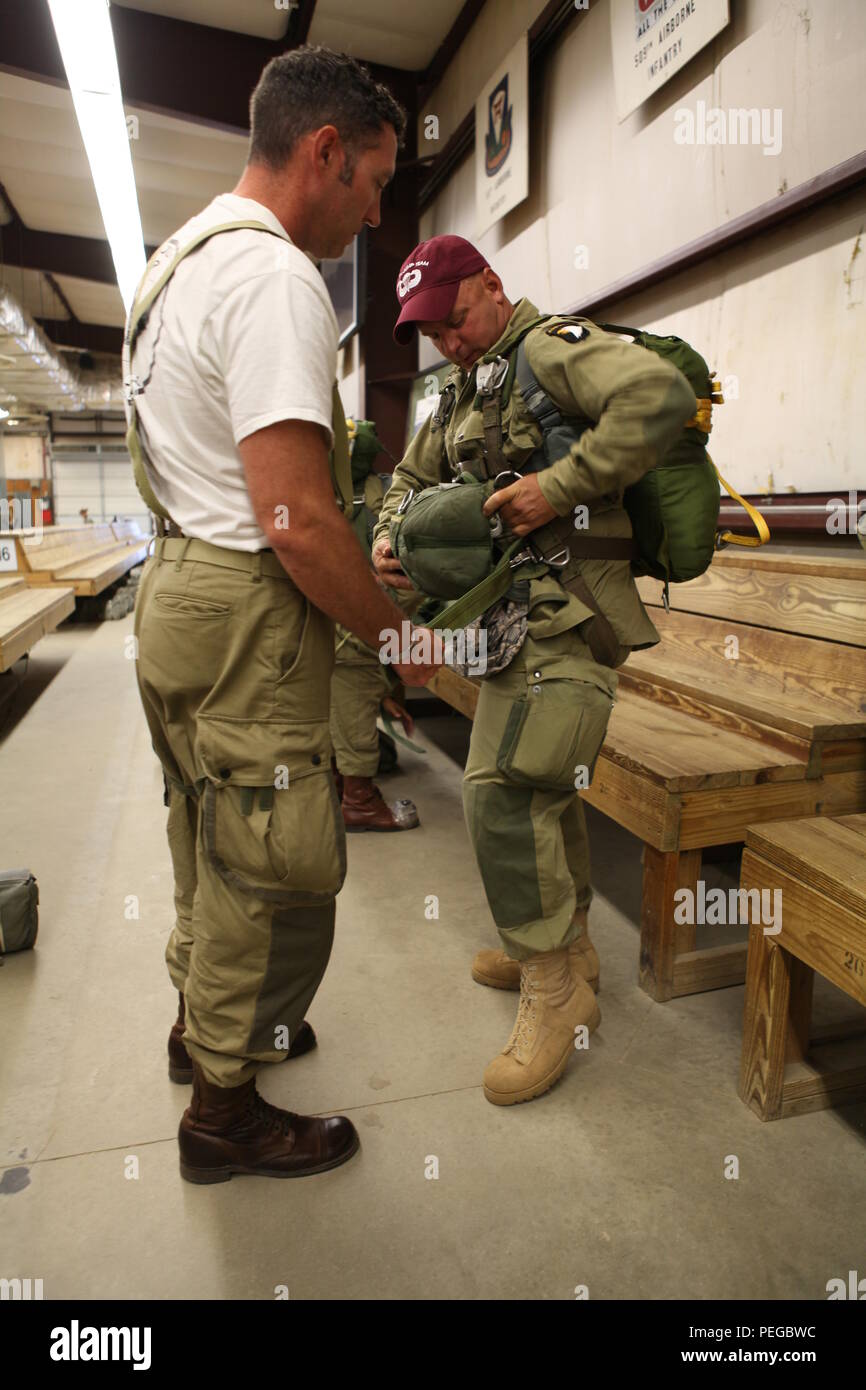 Bobby Gautier, ein Re-Enactor mit der Freiheit springen Team, aus Fort Worth, Texas, unterstützt die US Air Force Joseph Rodak, mit seiner Gang für Nachhaltige Airborne Training zog sich in der Vorbereitung für das 75-jährige Jubiläum der Luft Schule Sprung bei McCarthy Halle in Fort Benning, Ga., Nov. 14, 2015. Die 1-507 th Parachute Infantry Regiment (PIR) Bataillon feiert 75 Jahre der US Army Airborne School und die Erinnerung an den letzten qualifizierenden Springen der ersten Airborne test platoon am 15 August, 1940. (Foto von der U.S. Army Sgt. McTaggart, Phillip Jakob/Freigegeben) Stockfoto