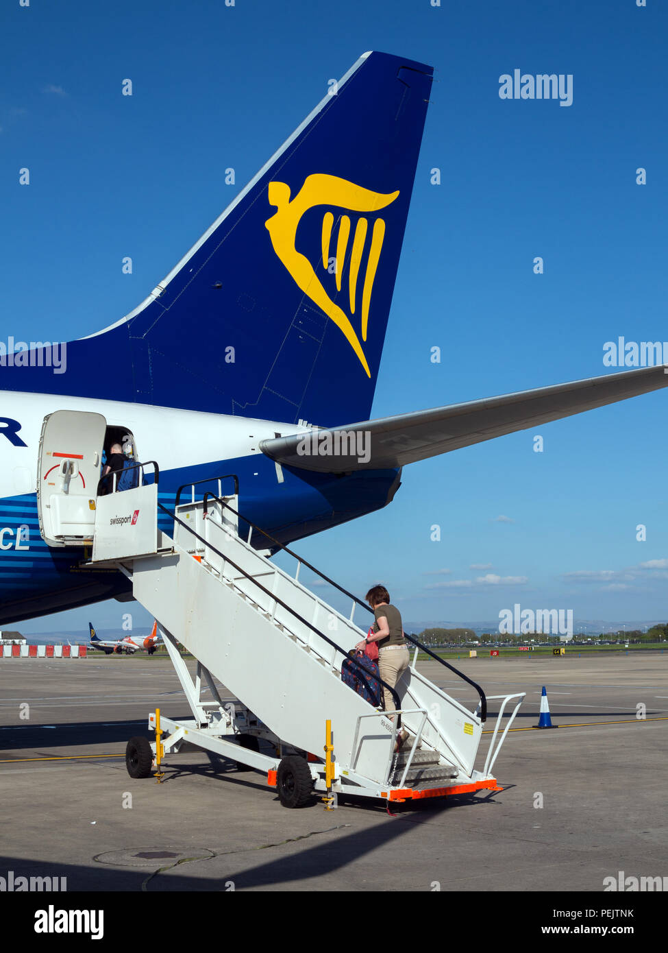 Die Passagiere aussteigen und Einsteigen in ein Budget Airline Flug von Ryanair auf der Start- und Landebahn am Flughafen Manchester England England Stockfoto