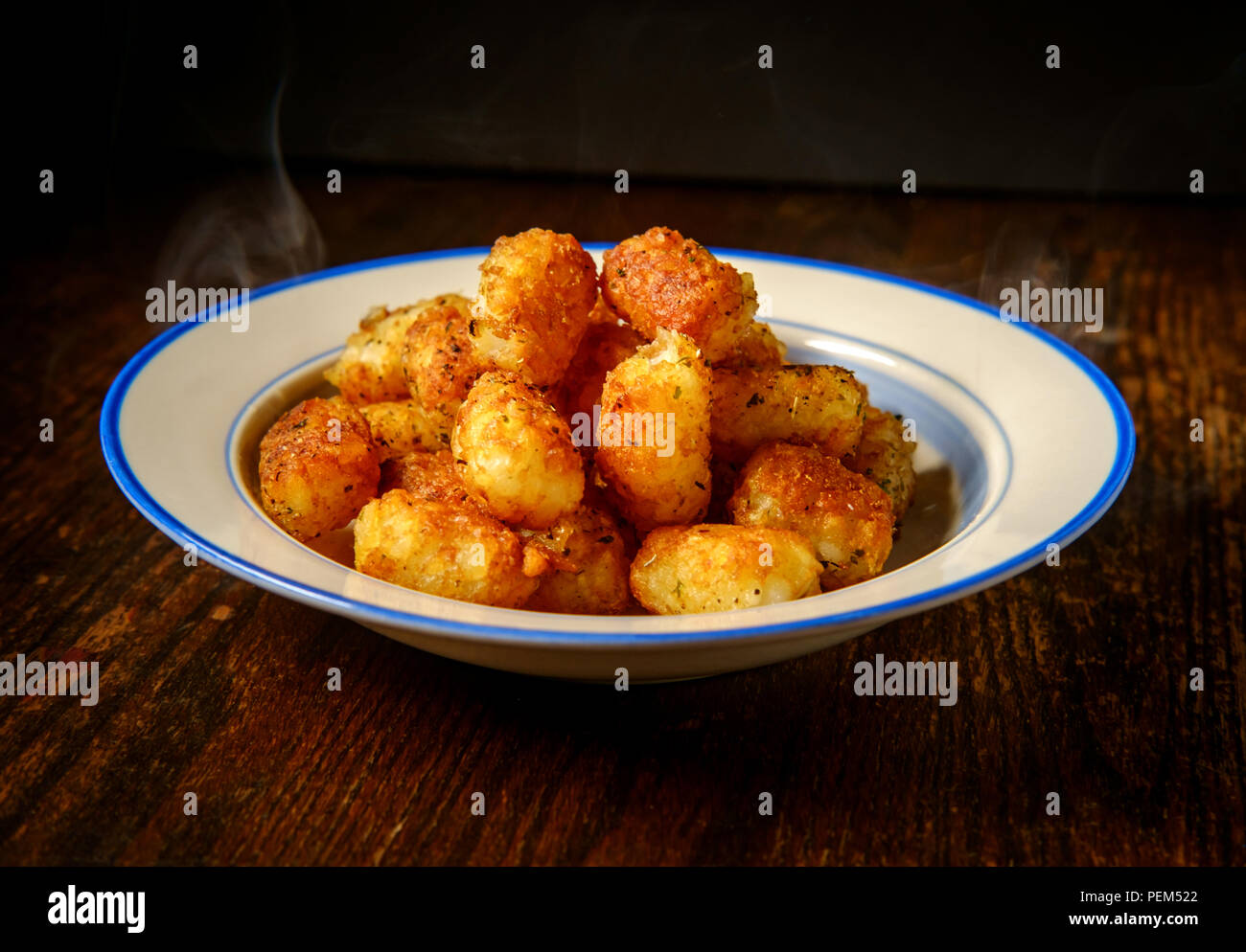 Schale mit frischen knusprigen Kartoffel Tater Tots auf rustikalen Tisch Stockfoto
