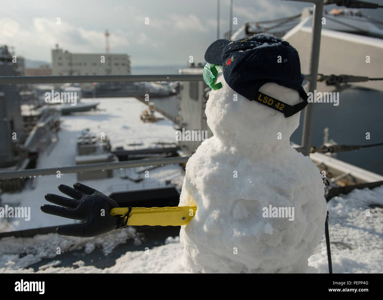 SASEBO, Japan (Jan. 25, 2016) ein Schneemann steht vor der Flight Deck der Amphibischen dock Landung Schiff USS Germantown (LSD 42) Bei einem Schneesturm. Germantown ist an die Bonhomme Richard Amphibious Ready Group (ARG) zugeordnet und ist derzeit in der Commander Flotte Aktivitäten Sasebo stationiert. (U.S. Marine Foto von Mass Communication Specialist 3. Klasse James Vazquez/Freigegeben) Stockfoto