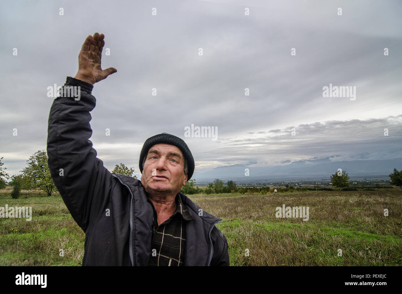 Der georgische Mann hebt seine Hände zum Himmel, zum Gott für mehr Trauben in Kachetien, Georgien Stockfoto