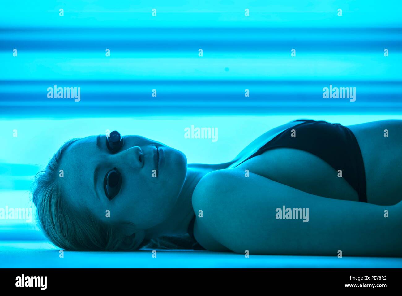 Frau tragen Schutzbrille Solarium. Stockfoto