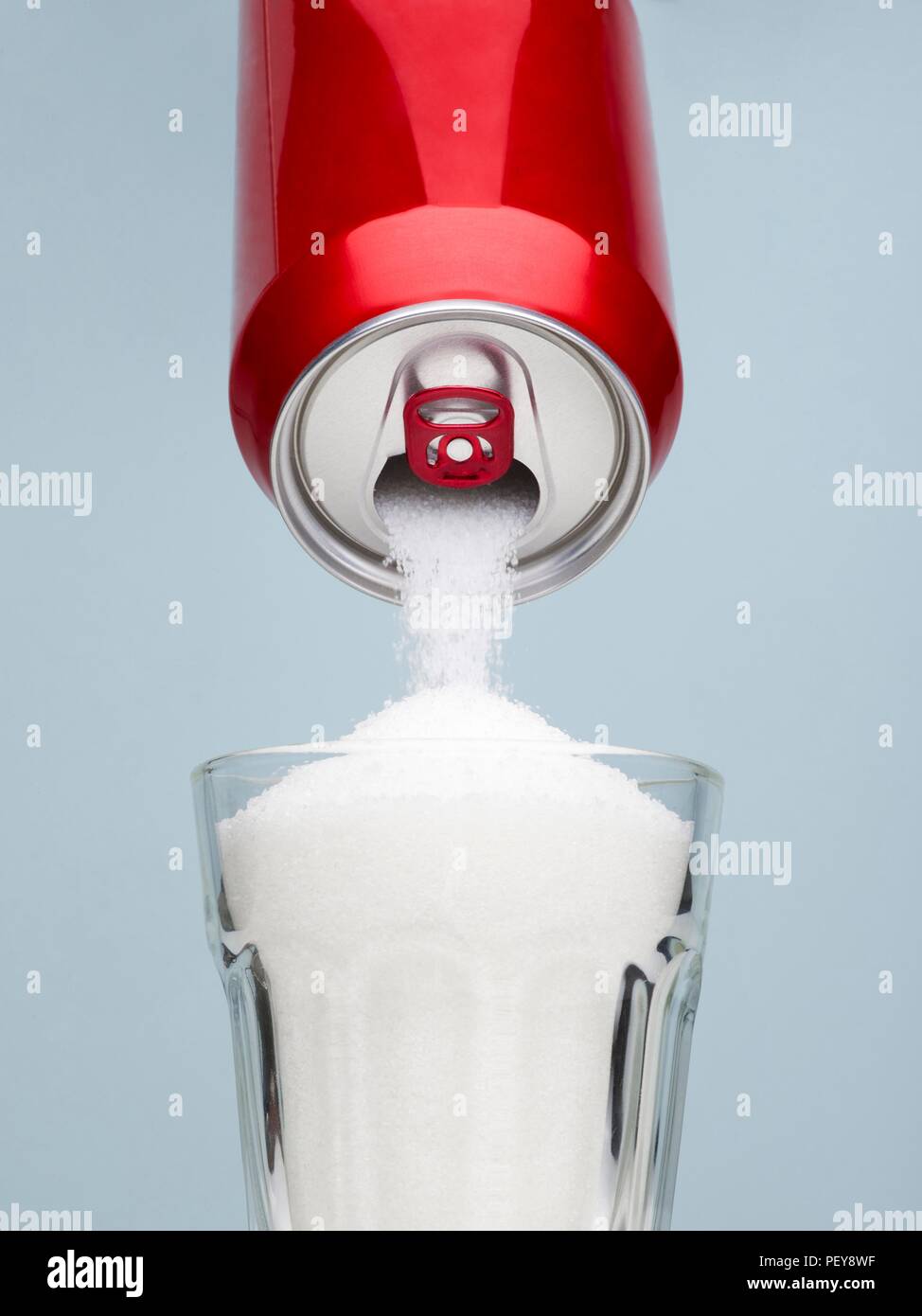 Zucker gießt aus einem Getränke können in ein Glas. Stockfoto