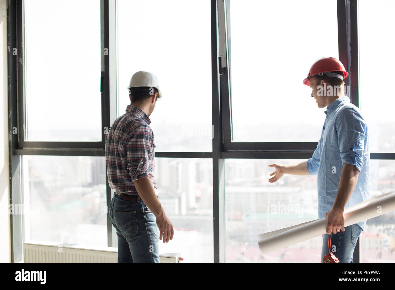 Zwei Erbauer sind Kontrolle der neuen Panorama windows im Bürogebäude Stockfoto