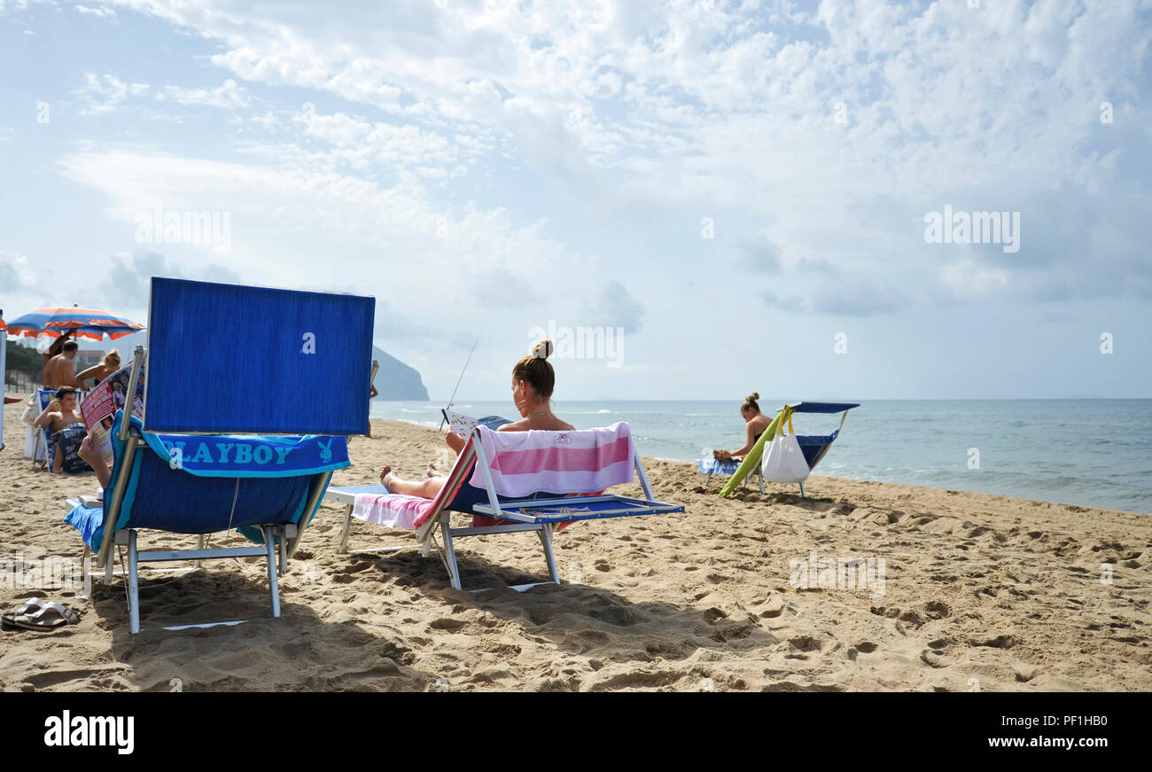 Sabaudia, Latium, Italien - 19 September 2017: Frauen am Strand entspannen durch Lesen klatsch Zeitschriften. Stockfoto