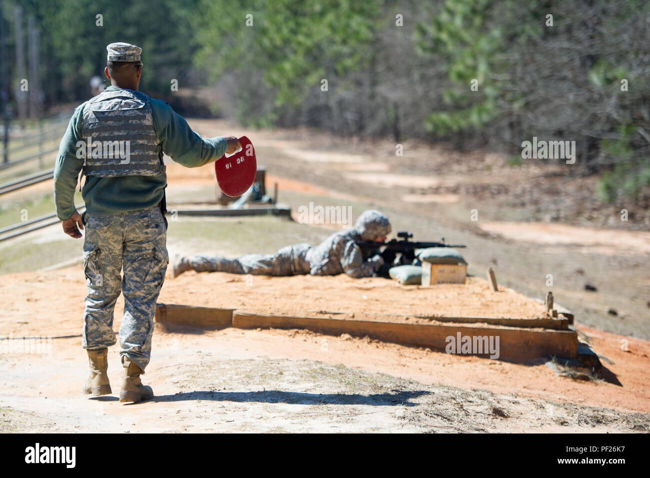 Ein US-Soldat an den HHC, 4-118 th kombinierte Waffen Bataillon, 218 Manöver Verbesserung Brigade, South Carolina Army National Guard, wartet mit dem All Clear Sicherheit bei der Qualifikation in Fort Jackson, S.C., Feb.27, 2016 in Reichweite zu Signal zugeordnet. Soldaten sind auf dem M4 Carbine jährlich im Rahmen der Ausbildung zum Soldaten Infanterie zu qualifizieren. (U.S. Air National Guard Foto von Tech. Sgt. Jorge Intriago) Stockfoto