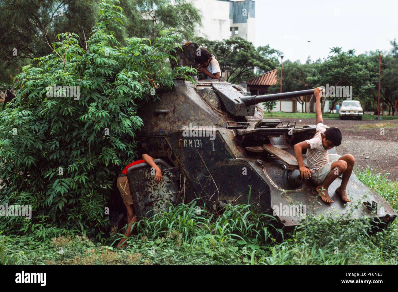 Managua, Nicaragua, Juni 1986; spielen die Kinder auf dem Havarierten bleibt der gepanzerten von Somoza Tanks und APCs im Zentrum von Managua. Es gab Destryed durch die Sandinistische Truppen im Bürgerkrieg gegen Somoza in 1979. Stockfoto