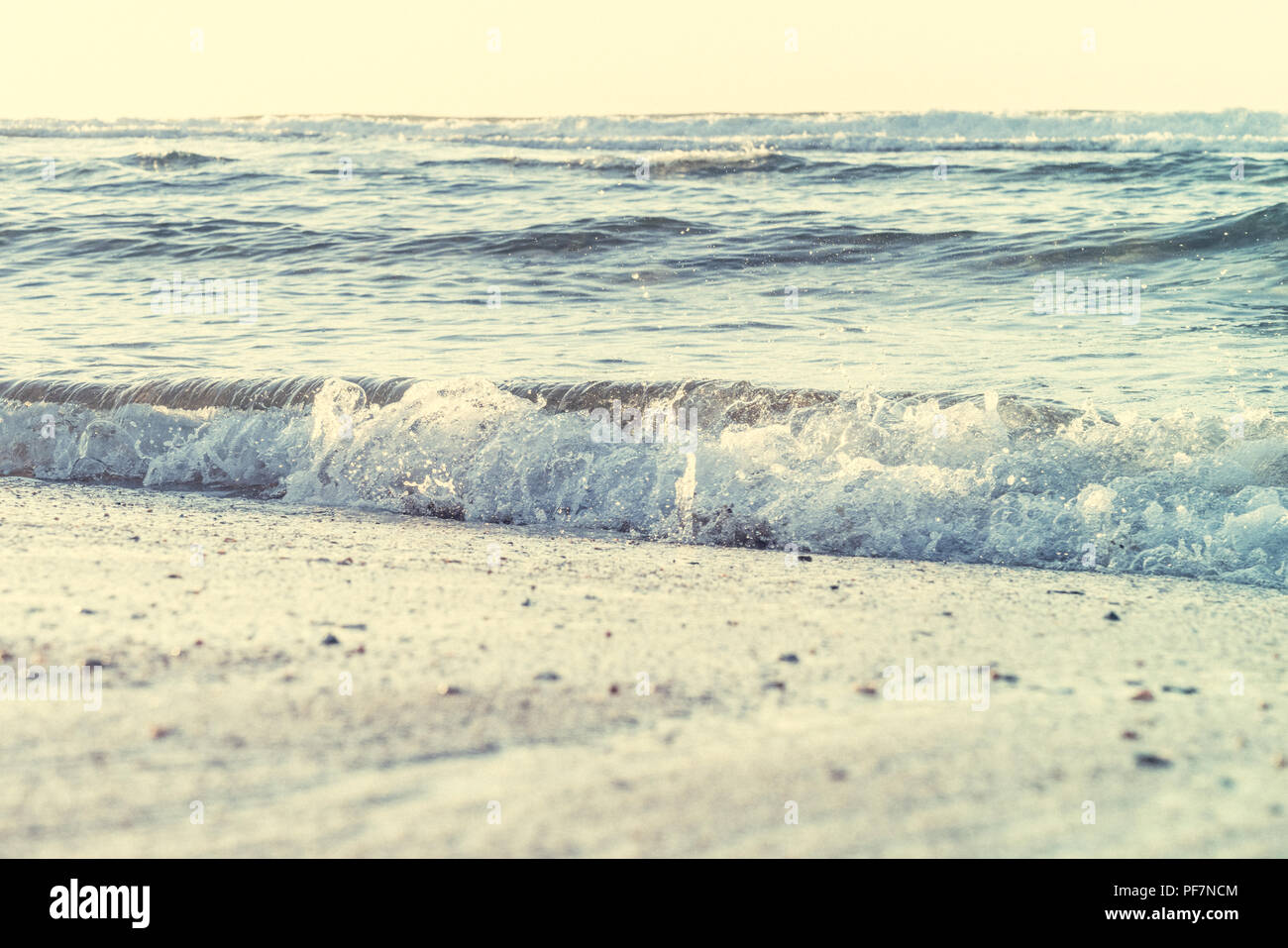 Hellen morgen mit Wellen, die an einem Strand Stockfoto