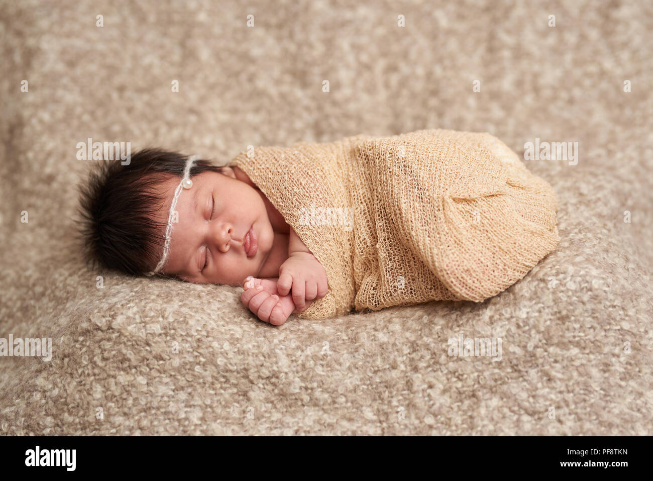 Kleines Baby schlafen auf Wrap in dunklen weiche Decke Stockfoto