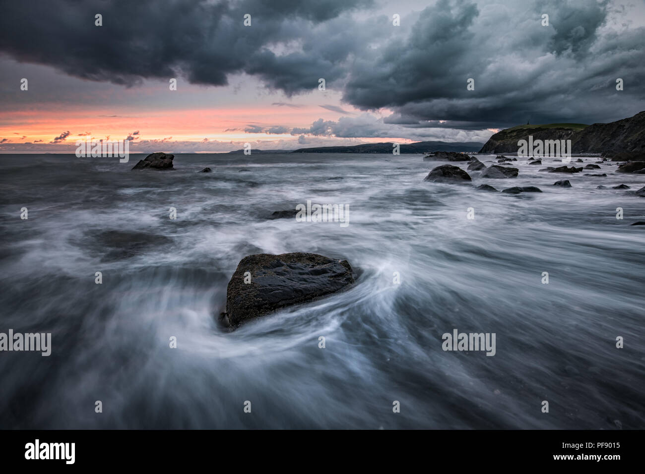 Eine stürmische Küsten Szene in Borth Strand bei Sonnenuntergang in Wales, Großbritannien Stockfoto