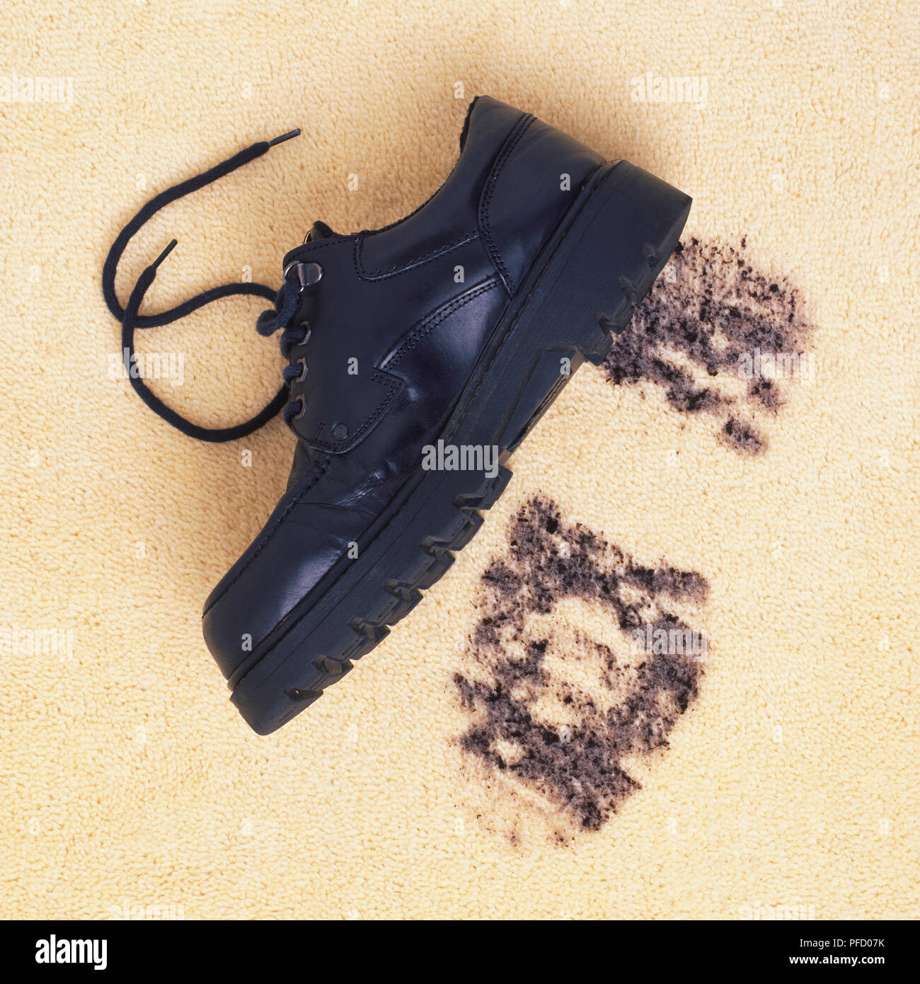 Dunkle Leder Schuh auf cremefarbenen Teppich weiter zu trüben Schuh - Drucken, Ansicht von vorne. Stockfoto
