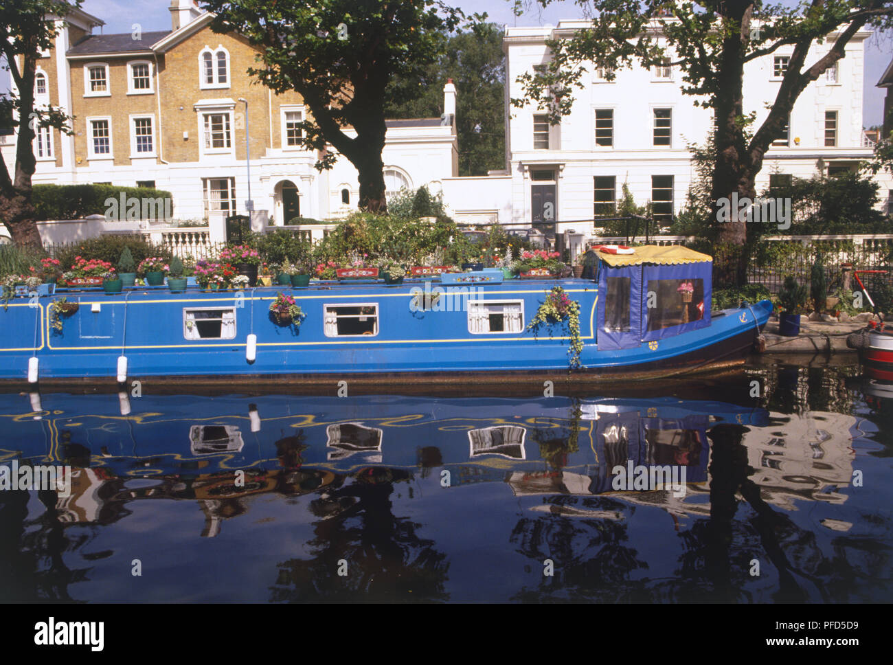 Vereinigtes Königreich, England, London, Regent's Canal, blau Hausboot im Wasser wider, bei der die Zeile der Edwardianischen Häuser im Hintergrund Stockfoto