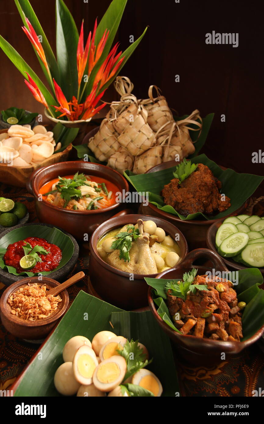 Ketupat Lebaran, die traditionelle feierliche Reisgericht mit Kuchen mit mehreren Beilagen; beliebt während Eid feiern. Stockfoto