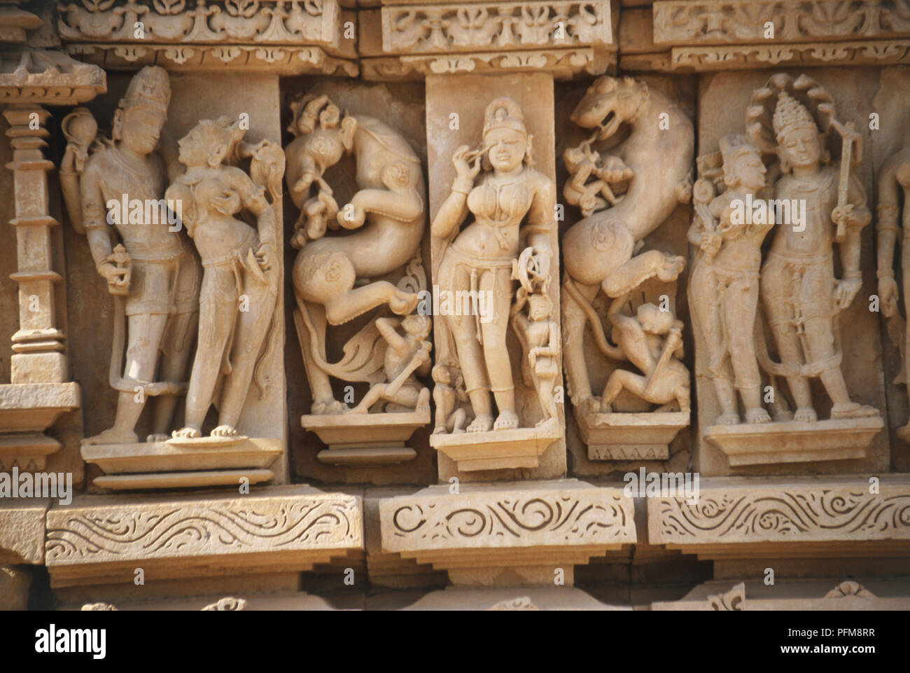 Gemeißelte Figuren auf dem parsvanath Tempel, Khajuraho, während der chandella Dynastie errichtet, zwischen 950 und 1050. Der Tempel, von denen nur etwa 20 bleiben, fallen unter 3 verschiedenen Gruppen und gehören zu zwei verschiedenen Religionen - Brahmanismus und Jaini. Stockfoto