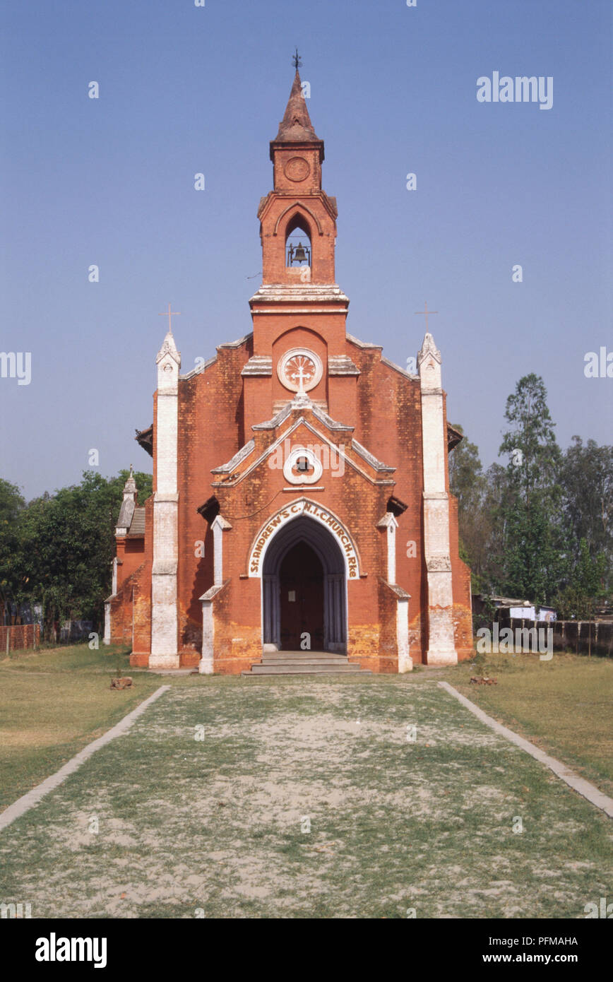 Indien, Roorkee, Fassade von St. Andrew's Church, roter Sandstein, hohen Glockenturm, zwei weiße Säulen mit Kreuzen, weißes Kreuz über Eingang Torbogen gekrönt. Stockfoto