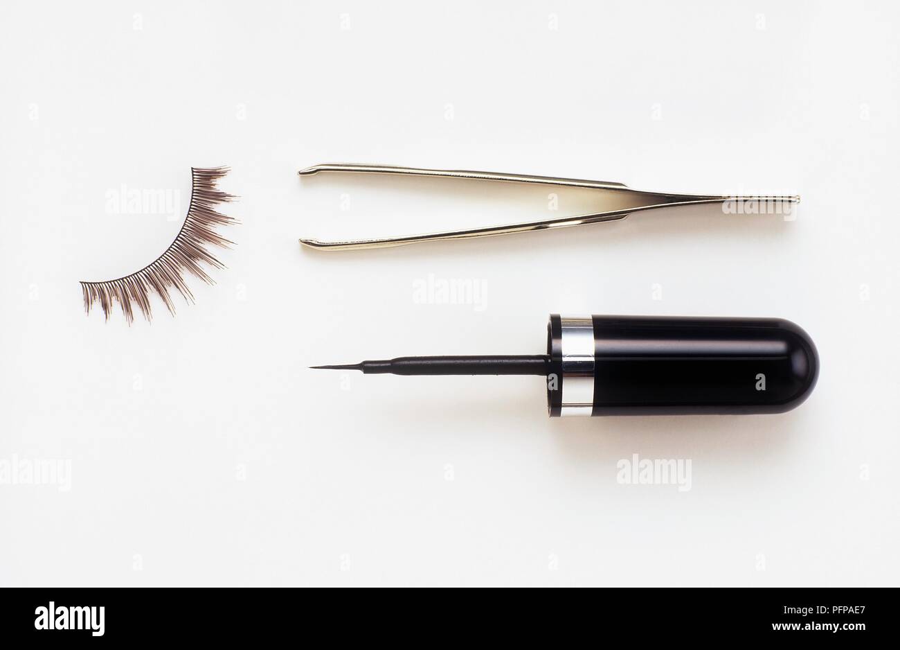 Liquid Eye Liner, falsche Wimpern und Pinzette Stockfoto