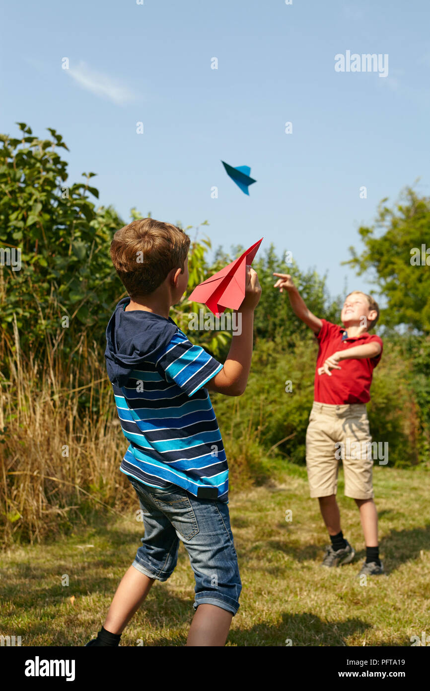 Jungen spielen mit Papierflieger Stockfoto