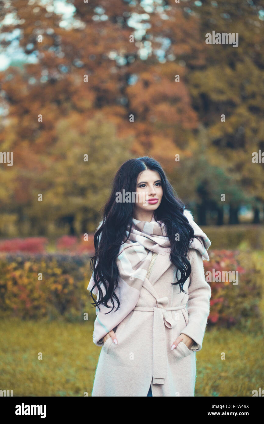 Attraktive Frau fashion model Brünette in Mantel auf Herbst park Hintergrund Stockfoto