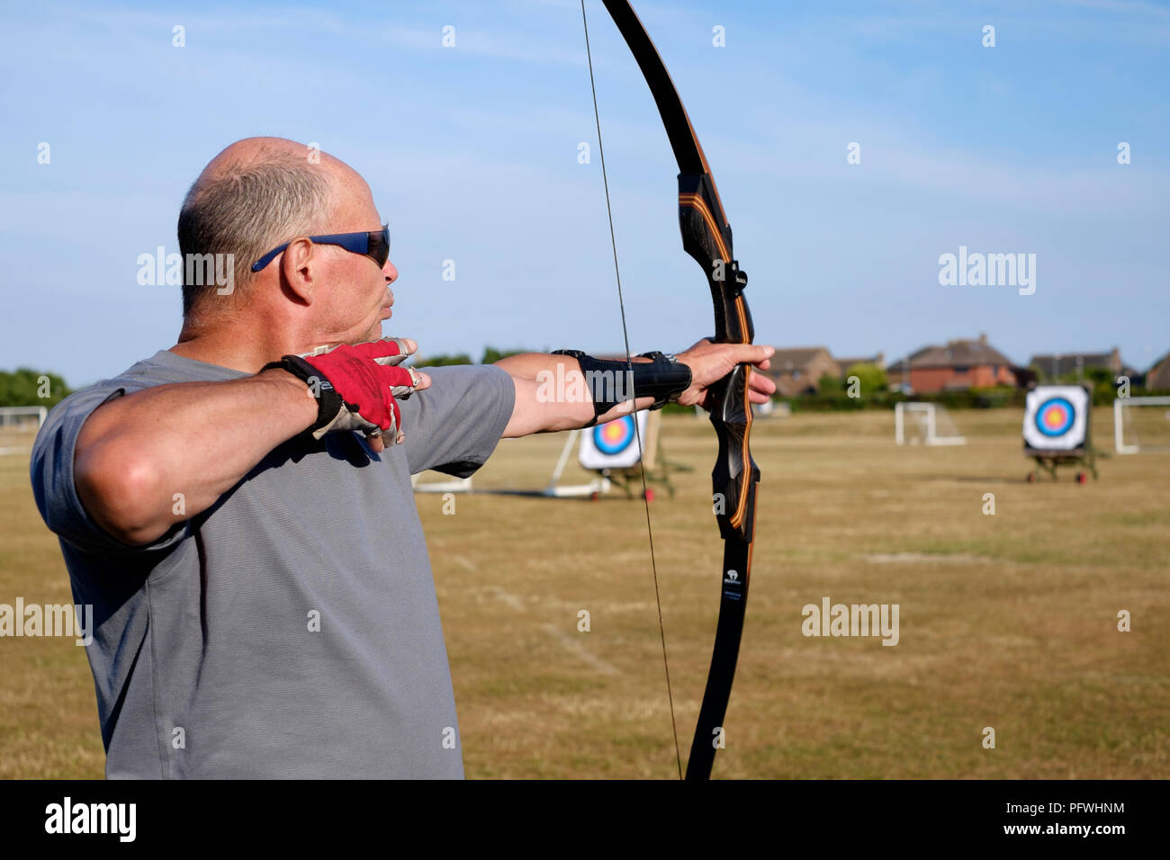 Männliche Archer mit einem Bogen für die Praxis zu einem Bogenschießen Club Stockfoto