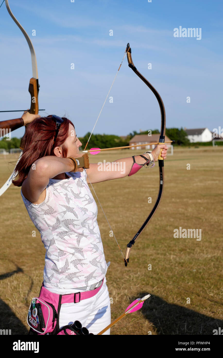 Weibliche Archer mit einem Bogen für die Praxis zu einem Bogenschießen Club Stockfoto