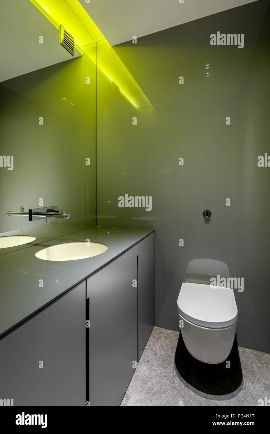 Einfaches Bad mit gelber LED-Licht, Wc und Arbeitsplatte Becken Stockfoto