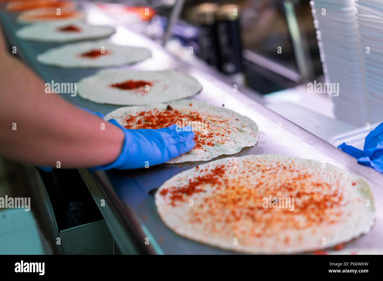 Frau in Marktstand Tortilla Wraps füllen Stockfoto